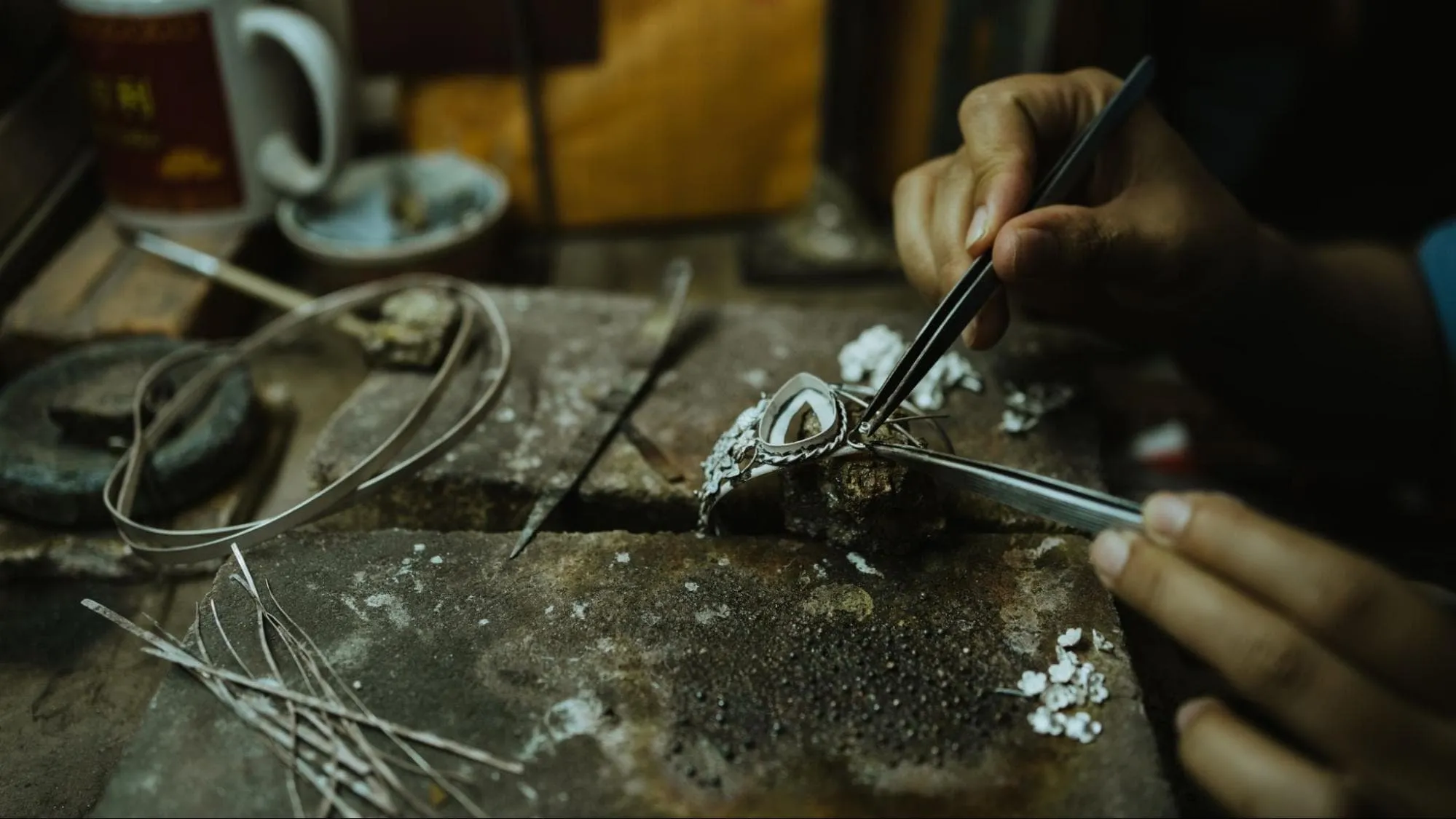 Artisan hands crafting custom jewelry